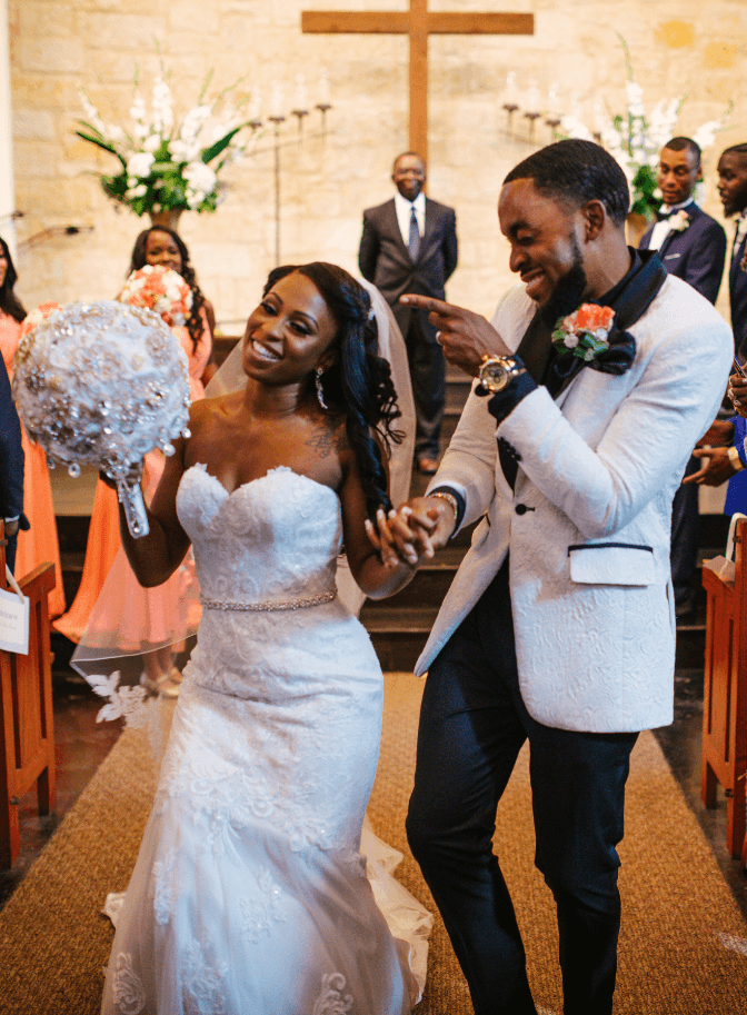 Bride and groom celebrating down the church aisle after the ceremony