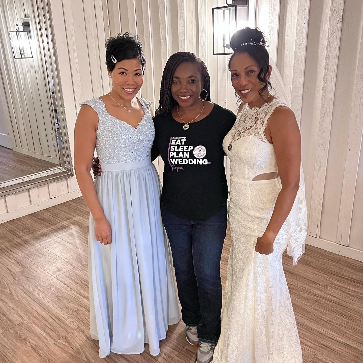 Wedding planner in an "Eat Sleep Plan Wedding" shirt with the bride and a bridesmaid