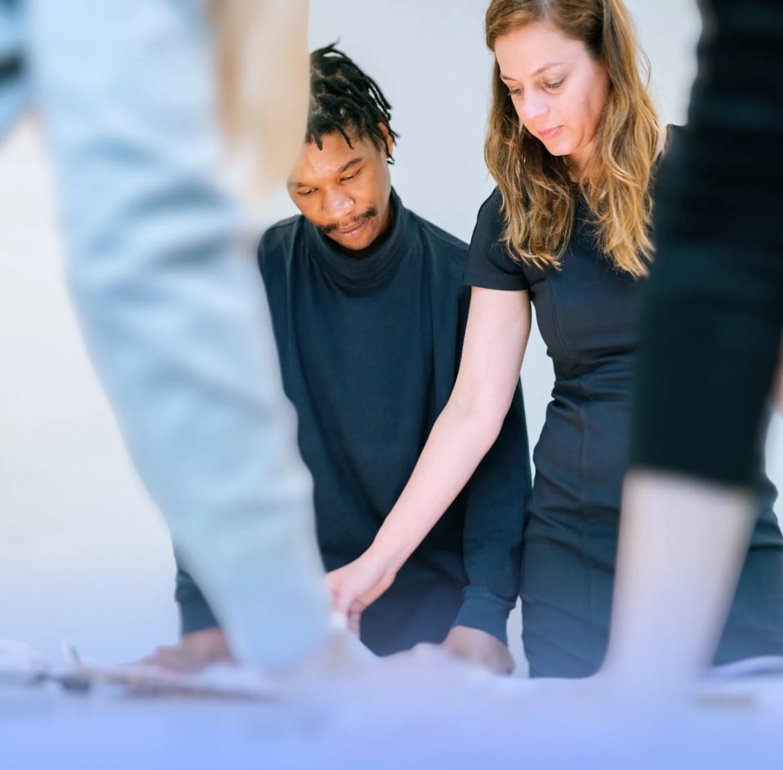 Two people working together over a table