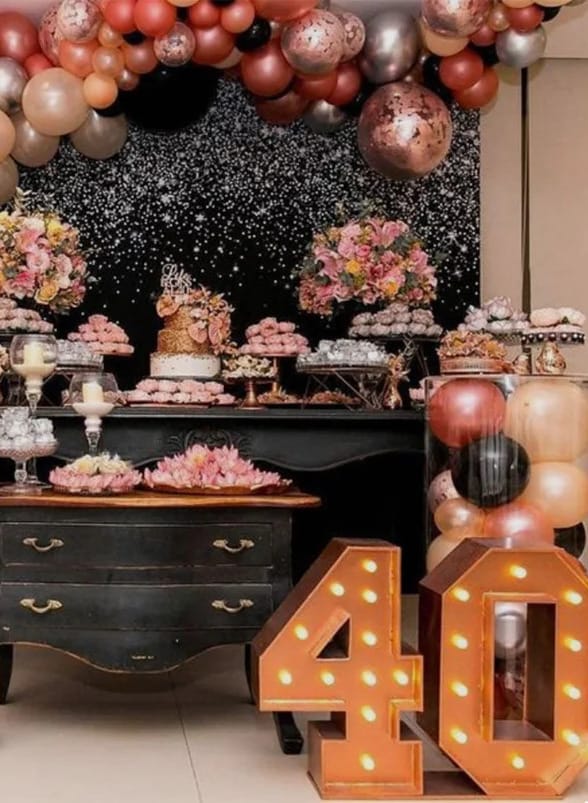 40th birthday dessert table with flowers, balloons and lighted marquee numbers